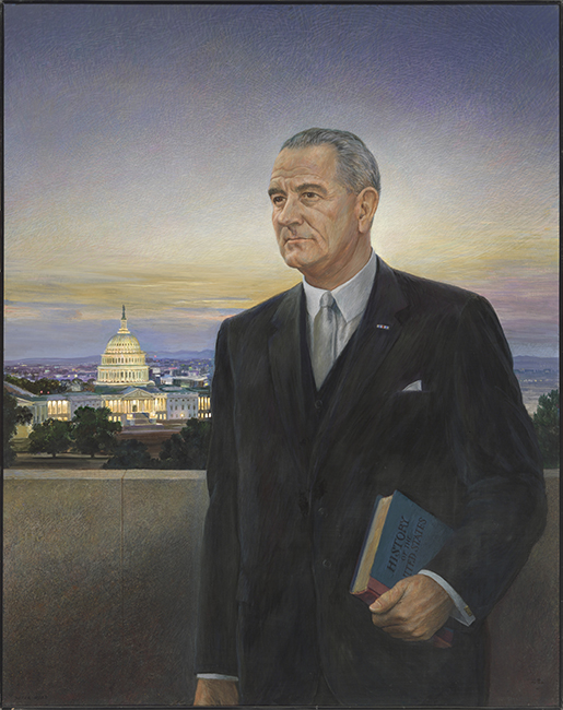 Man in a dark suit standing in front of the US Capitol