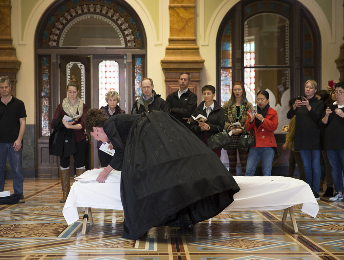 Woman putting a sheet on a cot