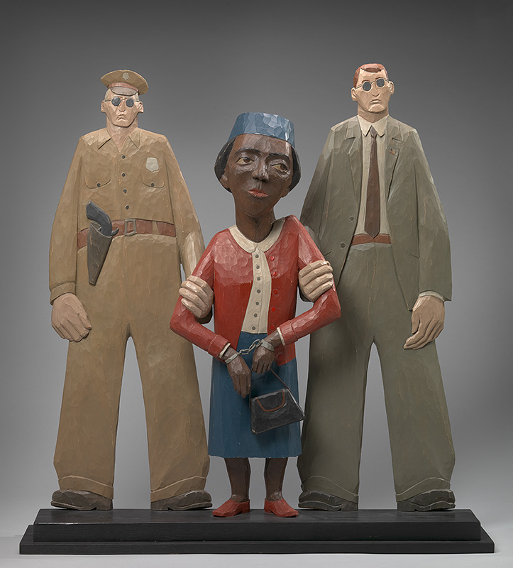Sculpture of a small African American woman with two police officers on either side of her