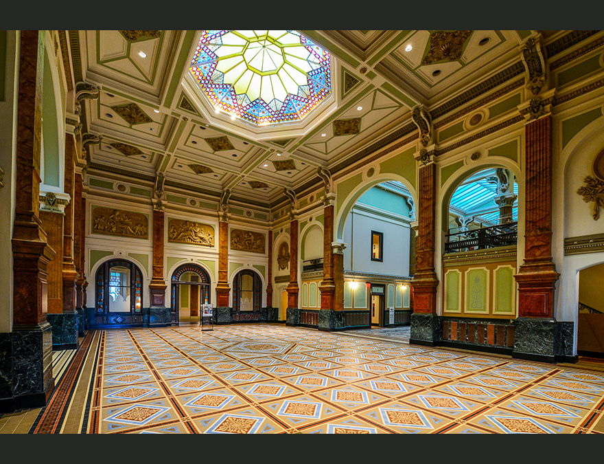 Great Hall with a tiled floor and stained glass ceiling