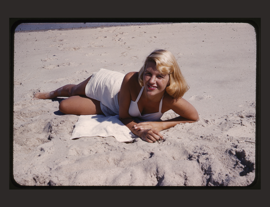 Woman in a white bathing suit on the beach