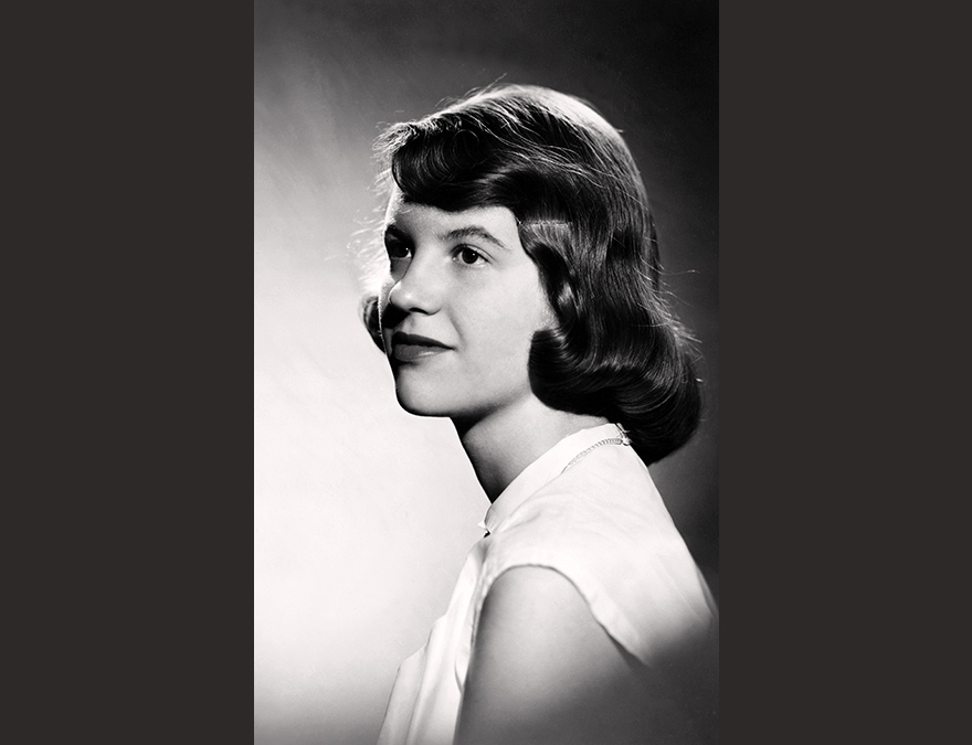 3/4 view of a young woman with a pageboy haircut in a with blouse