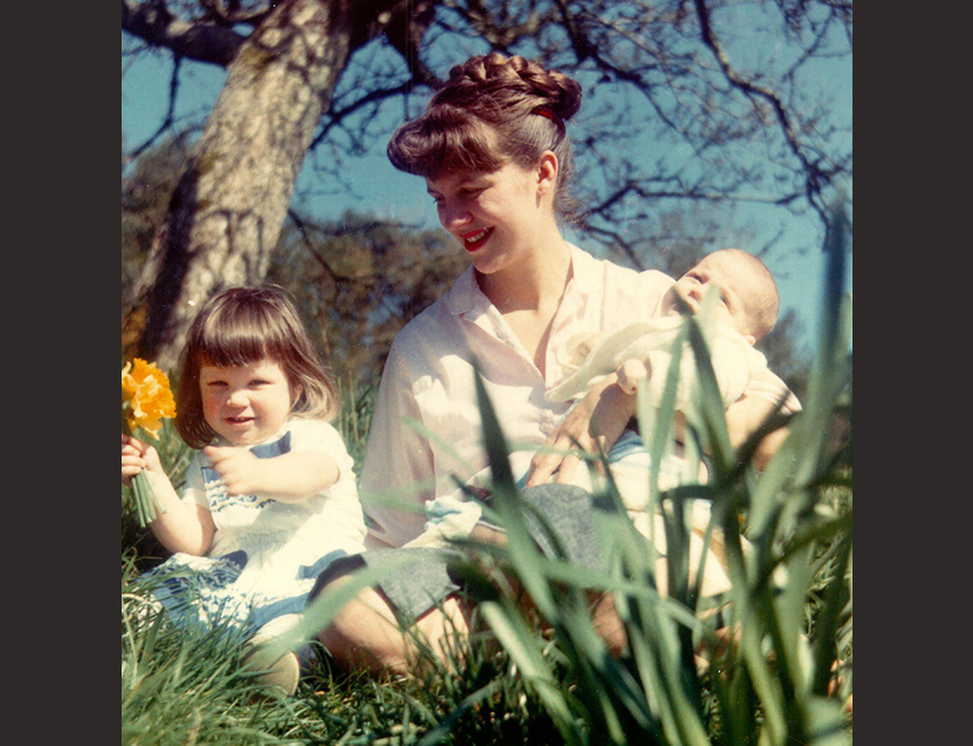 WOman in a garden with her two small children