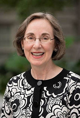 WOman with medium length brown hair and glasses