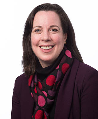 woman with brown hair wearing a bright scarf