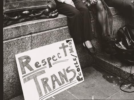 Black and white photo of Sylvia Rivera (with Christina Hayworth and Julia Murray) with sign reading "Respect Trans"