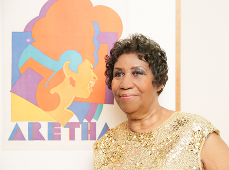 Aretha Franklin stands next to a poster of her at National Portrait Gallery