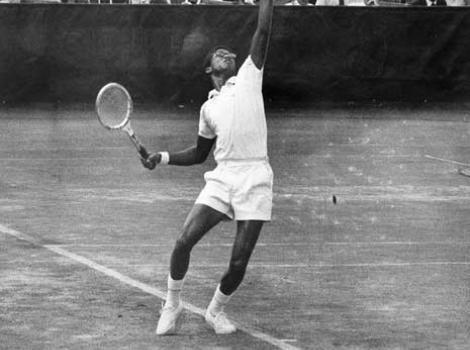 Black and white portait of Arthur Ashe serving