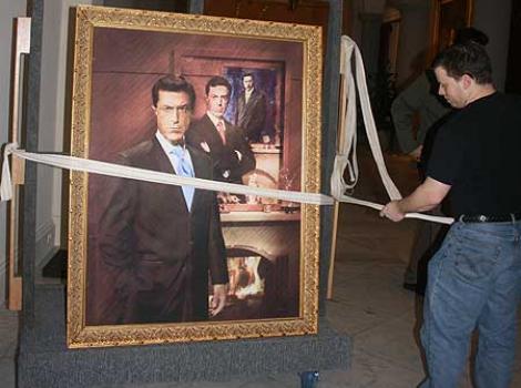 Stephen Colber's portrait being moved