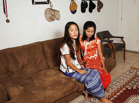 Two young women sitting on a couch