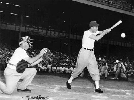 Black and white photo of Joe DiMaggio at home plate, hitting ball during a game