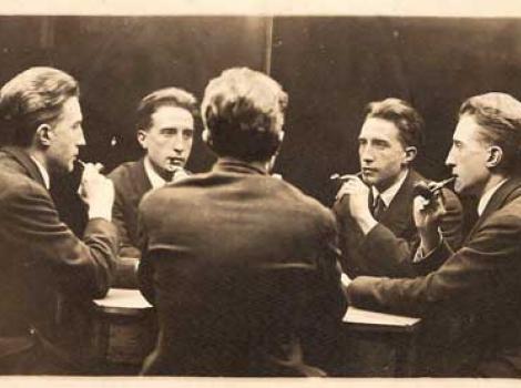 Photograph of five Marcel Duchamp's sitting around table