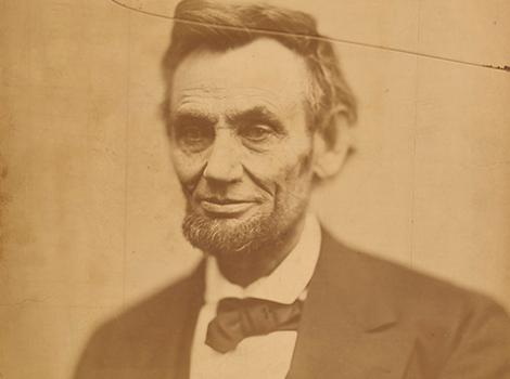 Photograph of Abe Lincoln, with a crack running through upper portion of the image