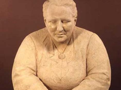 Sculpture of Gertrude Stein, seated with hands in lap