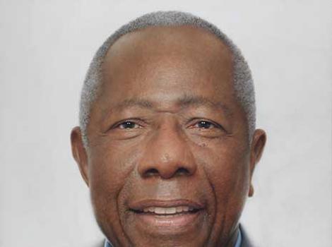 Oil painting of Hank Aaron from the shoulders up, wearing a gray suit jacket, in front of a white background.