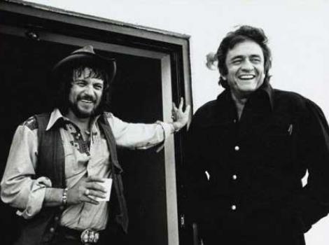 Black and white photo of Johnny Cash and Wylon Jennings, casually dressed and both smiling