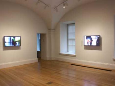 View of video screens showing LIncoln Schatz's work in the museum galleries
