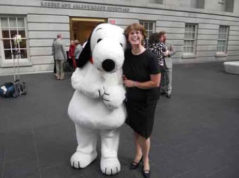 Molly Grimsley with Snoopy in museum courtyard