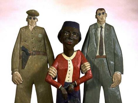 Sculpture of Rosa Parks in handcuffs being arrested by two men.