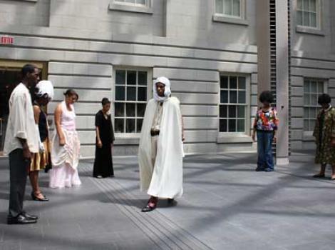 Teen students performing "Portraits Alive!" in museum courtyard