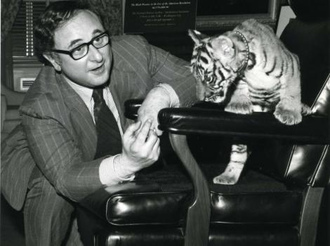 Black and white photo of Marvin Sadik with a baby tiger