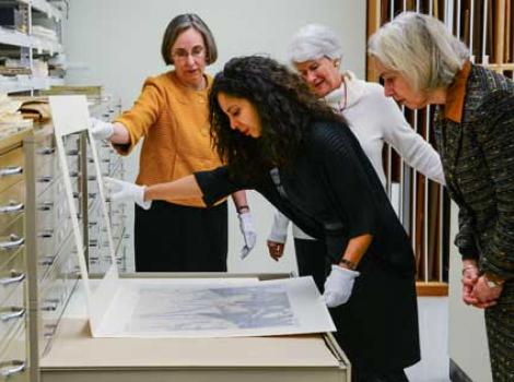 Taina Caragol looking at portraits in the museum's collections