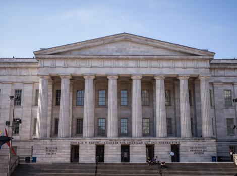 Photograph of building with columns against a blue sky