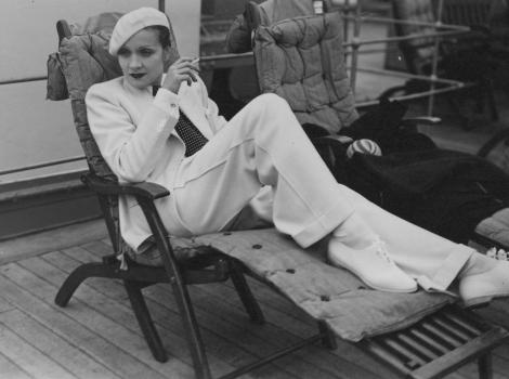 Black and white photograph of a woman smoking on a chaise lounge