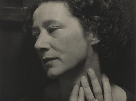 Sepia tone photograph of a woman with her hands on her neck
