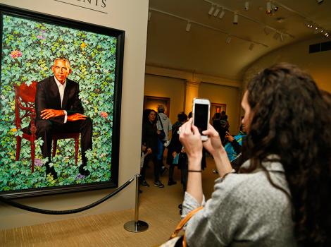 Visitor taking a photo of the Obama portrait
