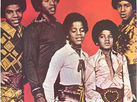 Color photo of the music group The Jackson Five with red background