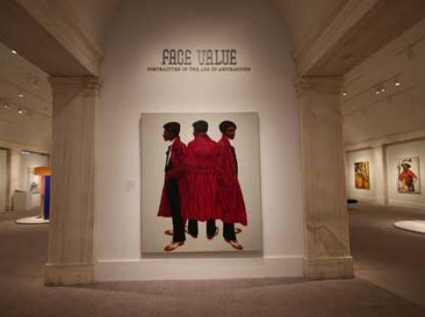Color photo of the entrance of the Face Value exhibition, showing various artworks.