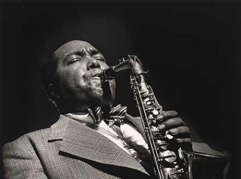 Black and white photo of Charlie Parker playing the saxophone