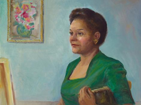 knee length portrait of a seated woman in a green dress