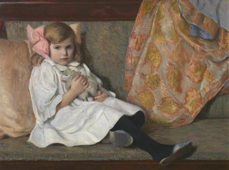 Little girl reclining on a couch