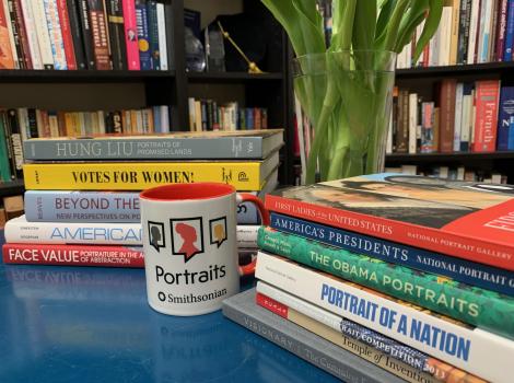 Desk with colorful books and a mug