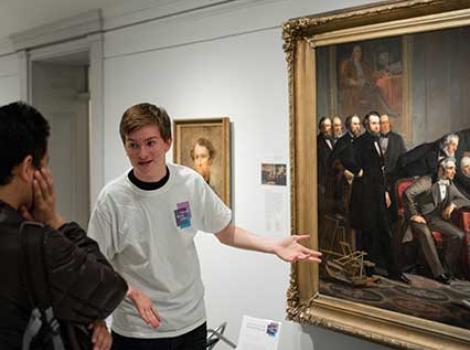 Teen gesturing at a painting