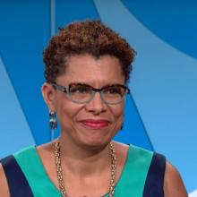 Woman with short hair against a colorful blue background