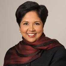 bulst length photo of a woman with dark hair wearing a scarf