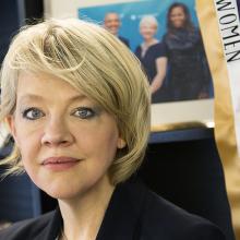 Close up photo of a woman with blond hair and blue eyes
