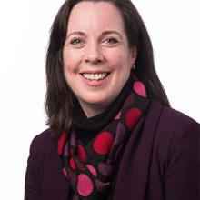 photo of a young woman with dark hair wearing a colorful scarf