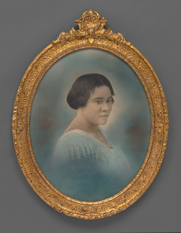 Oval, bust-length, crayon portrait of a Black woman in a blue dress