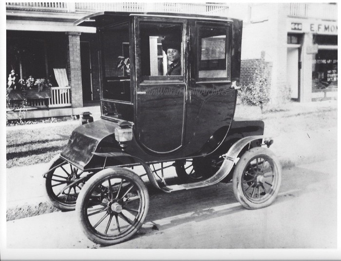 Black woman driving an electric car c. 1910