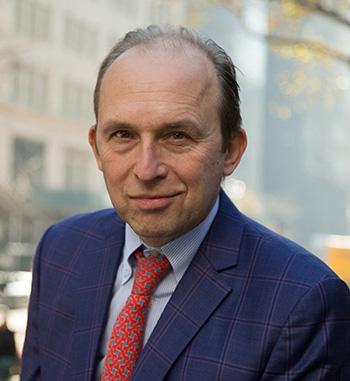 middle-aged man in a blue jacket with a red tie